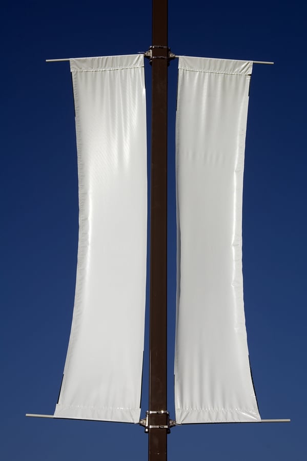 Twin white banners on pole in sunlight - add your own message